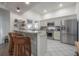 Open kitchen featuring stainless appliances, granite counters, breakfast bar and white tiled floor at 409 E Frances Ave, Tampa, FL 33602