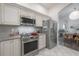 Kitchen featuring stainless steel appliances, granite countertops and tiled backsplash at 409 E Frances Ave, Tampa, FL 33602