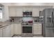 Bright kitchen featuring stainless steel appliances, granite countertops and tiled backsplash at 409 E Frances Ave, Tampa, FL 33602