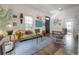 Cozy living room featuring a comfortable sofa, stylish decor, hardwood floors, and natural light at 409 E Frances Ave, Tampa, FL 33602