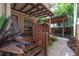 Wooden deck and brick patio surrounded by lush greenery, perfect for relaxing or entertaining outdoors at 409 E Frances Ave, Tampa, FL 33602