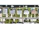 Overhead view of a waterfront house with manicured lawn, and the adjacent street at 4123 Daisy Dr, Hernando Beach, FL 34607