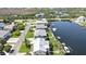 Wide aerial view of waterfront homes along a canal, complete with docks, boats and vibrant greenery at 4123 Daisy Dr, Hernando Beach, FL 34607