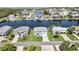 Stunning aerial view of a waterfront home with a well-kept lawn, set amidst a serene coastal neighborhood at 4123 Daisy Dr, Hernando Beach, FL 34607