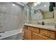 Bathroom showcasing tiled walls, granite countertop vanity, and modern fixtures at 4123 Daisy Dr, Hernando Beach, FL 34607