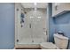 Modern bathroom with a glass-enclosed shower, white tile, and a white toilet at 4123 Daisy Dr, Hernando Beach, FL 34607
