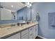 Bright bathroom features a double vanity, white cabinets, and blue walls at 4123 Daisy Dr, Hernando Beach, FL 34607