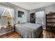 Comfortable bedroom with wood floors, a decorative cabinet and picturesque water view at 4123 Daisy Dr, Hernando Beach, FL 34607