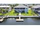 Waterfront home with a private dock, well-maintained lawn, mature landscaping, and a screened upper porch at 4123 Daisy Dr, Hernando Beach, FL 34607