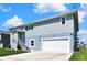 Two-story home with a ground level garage and stairwell to the main floor and front entrance at 4123 Daisy Dr, Hernando Beach, FL 34607