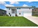 Charming two-story home with a well-manicured lawn and attached garage, showcasing its inviting curb appeal at 4123 Daisy Dr, Hernando Beach, FL 34607