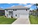 Beautiful two-story home with a well-manicured lawn and an attached two-car garage near a canal at 4123 Daisy Dr, Hernando Beach, FL 34607