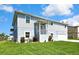 Beautiful two-story home with a well-maintained lawn, front entry and an attached garage on a sunny day at 4123 Daisy Dr, Hernando Beach, FL 34607