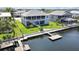 Beautiful waterfront home featuring a private dock, lush lawn, and a screened upper porch at 4123 Daisy Dr, Hernando Beach, FL 34607