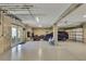 Spacious garage with fishing rod racks, car, and lawn equipment, ideal for hobbyists and car enthusiasts at 4123 Daisy Dr, Hernando Beach, FL 34607