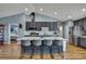 Modern kitchen showcasing gray cabinets, a large kitchen island with seating, and stainless steel appliances at 4123 Daisy Dr, Hernando Beach, FL 34607