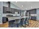 Modern kitchen featuring stainless steel appliances, a large island with seating, and stylish gray cabinetry at 4123 Daisy Dr, Hernando Beach, FL 34607