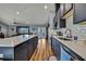 A spacious kitchen includes an island with a white countertop, dark cabinets and stainless appliances at 4123 Daisy Dr, Hernando Beach, FL 34607