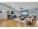 Inviting living room featuring a vaulted ceiling, hardwood floors, and comfortable seating around a central coffee table at 4123 Daisy Dr, Hernando Beach, FL 34607