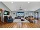 Spacious living room with hardwood floors, neutral walls, ceiling fan, and comfortable seating arrangements at 4123 Daisy Dr, Hernando Beach, FL 34607
