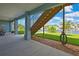 Covered patio featuring access to the canal, lawn, and stairway, providing a scenic and relaxing outdoor living space at 4123 Daisy Dr, Hernando Beach, FL 34607