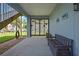 Outdoor patio with access to the canal and backyard, with a storage bench and tropical decor, perfect for relaxation at 4123 Daisy Dr, Hernando Beach, FL 34607