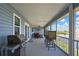 Inviting screened porch with grill and water views, perfect for outdoor relaxation at 4123 Daisy Dr, Hernando Beach, FL 34607