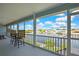 Enclosed porch providing stunning water views, complete with outdoor seating at 4123 Daisy Dr, Hernando Beach, FL 34607