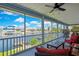 Enclosed porch providing stunning water views, complete with outdoor seating at 4123 Daisy Dr, Hernando Beach, FL 34607