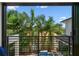 Balcony with a view of palm trees and the pool, showcasing the outdoor living space at 443 Lucerne Ave, Tampa, FL 33606