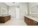 Bright bathroom with dual sinks, modern vanities, neutral color palette, and contemporary lighting at 443 Lucerne Ave, Tampa, FL 33606