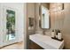 Modern bathroom featuring a sleek vanity, designer lighting, and door to a pool at 443 Lucerne Ave, Tampa, FL 33606