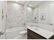 Modern bathroom features marble tile, a soaking tub, and sleek vanity with a large mirror at 443 Lucerne Ave, Tampa, FL 33606