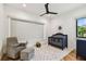 Well-lit Bedroom with a dark wood crib, soft chair, and a ceiling fan at 443 Lucerne Ave, Tampa, FL 33606