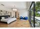 Bedroom with a large bed, hardwood floors, sitting area and access to the balcony at 443 Lucerne Ave, Tampa, FL 33606