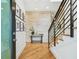 Bright entryway with hardwood floors, stone accent wall, modern staircase, and stylish decor at 443 Lucerne Ave, Tampa, FL 33606