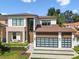 Beautiful two-story home with a modern design, two car garage, manicured lawn and a stone facade at 443 Lucerne Ave, Tampa, FL 33606