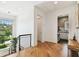 Upstairs hallway featuring wood floors, large window with view, and nearby laundry room at 443 Lucerne Ave, Tampa, FL 33606