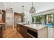 Modern kitchen featuring an island, stainless steel appliances, and hardwood floors at 443 Lucerne Ave, Tampa, FL 33606
