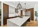 Spacious kitchen with island, marble countertops, stainless steel appliances, and stylish pendant lighting at 443 Lucerne Ave, Tampa, FL 33606