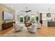 Bright living room with hardwood floors, stylish furniture, and views of the backyard and adjoining kitchen at 443 Lucerne Ave, Tampa, FL 33606