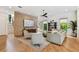 Cozy living room featuring hardwood floors, modern furnishings, a stone accent wall, and plenty of natural light at 443 Lucerne Ave, Tampa, FL 33606