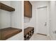 Mudroom features wood shelves, built-in bench, and ample storage at 443 Lucerne Ave, Tampa, FL 33606