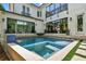 Contemporary home showcasing a modern pool, clean lines, and lush landscaping at 443 Lucerne Ave, Tampa, FL 33606