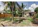 Spacious backyard featuring green grass, garden with lush plants, and fruit trees at 4479 Newark N St, St Petersburg, FL 33714