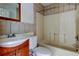 Shows bathroom with white toilet, sink and vanity, and shower-tub combo at 4479 Newark N St, St Petersburg, FL 33714