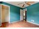 Spacious bedroom features wood-look floors, teal walls, and a closet at 4479 Newark N St, St Petersburg, FL 33714