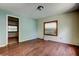 View of bedroom with wood flooring, light blue walls, and a window with blinds at 4479 Newark N St, St Petersburg, FL 33714