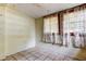 Bedroom with tile flooring, curtains, and wall outlet at 4479 Newark N St, St Petersburg, FL 33714
