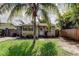 Charming single-story home with a tropical landscaped front yard and driveway at 4479 Newark N St, St Petersburg, FL 33714